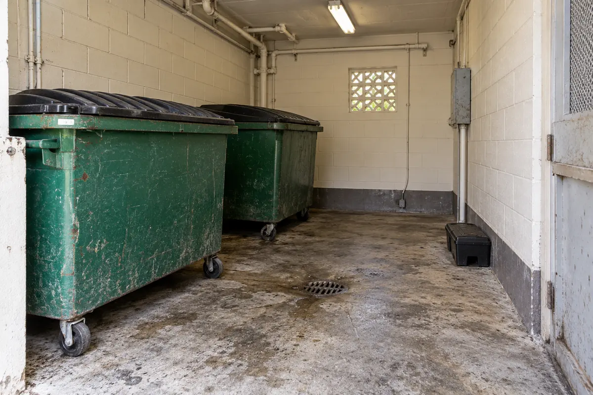 Dumpster room with a bait station along the wall, commercial mold remediation in Oklahoma City, OK